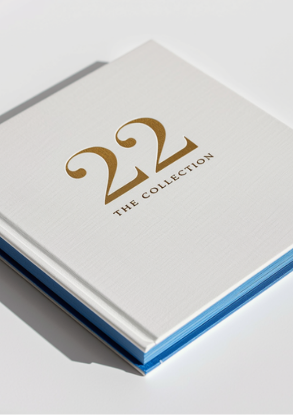 22 THE COLLECTION — luxury hardcover with gold foil typography and Klein Blue sprayed edges